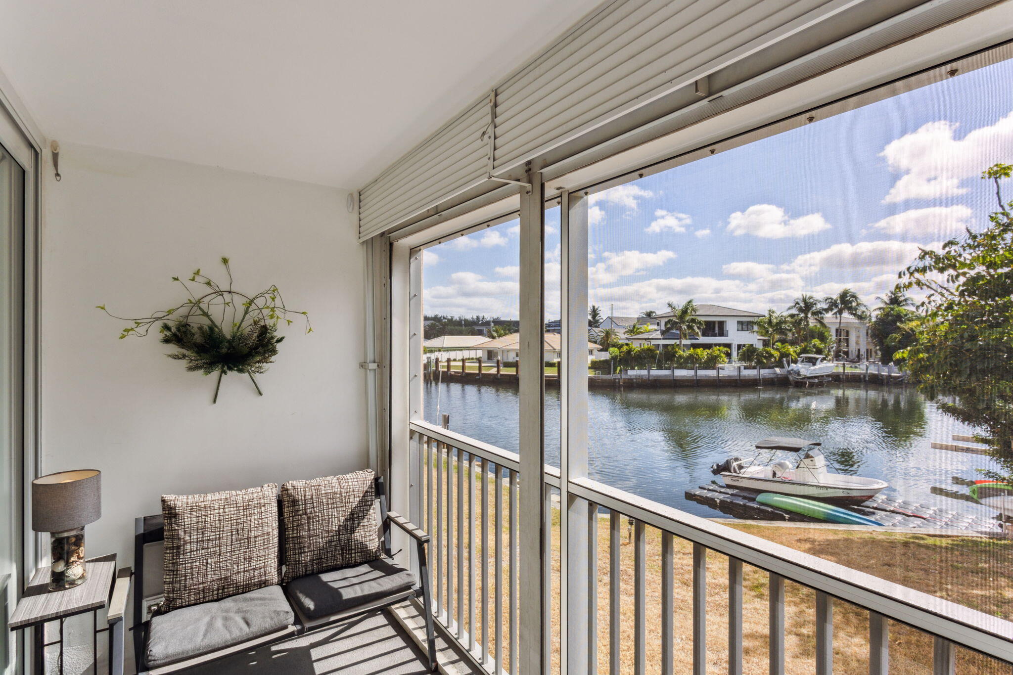 698 Northeast Spanish River Boulevard, Unit 24 Boca Raton, FL 33431 - Photo 12 of 25 a balcony with an outdoor seating