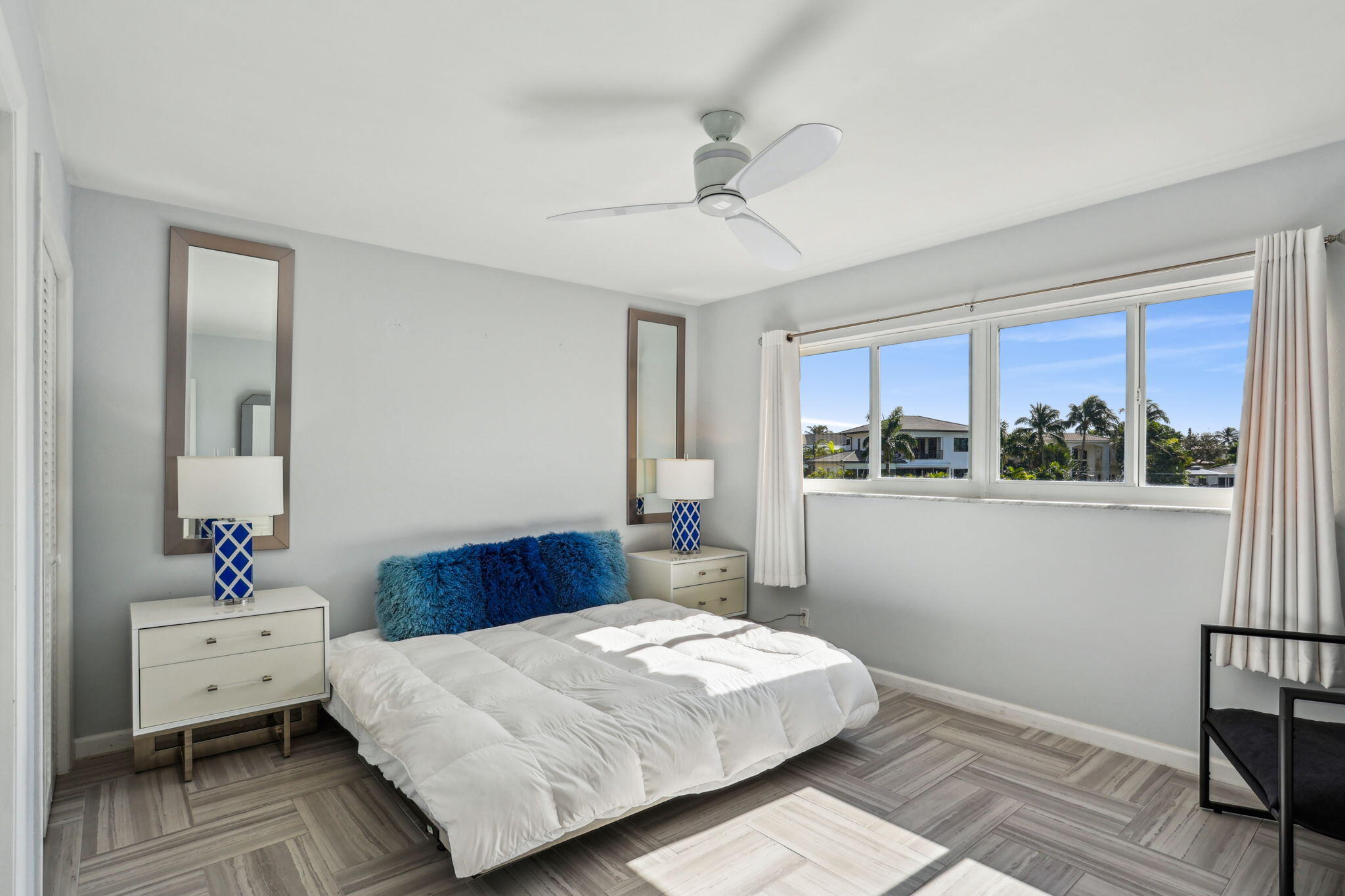 698 Northeast Spanish River Boulevard, Unit 24 Boca Raton, FL 33431 - Photo 14 of 25 a bedroom with a bed and wooden floor