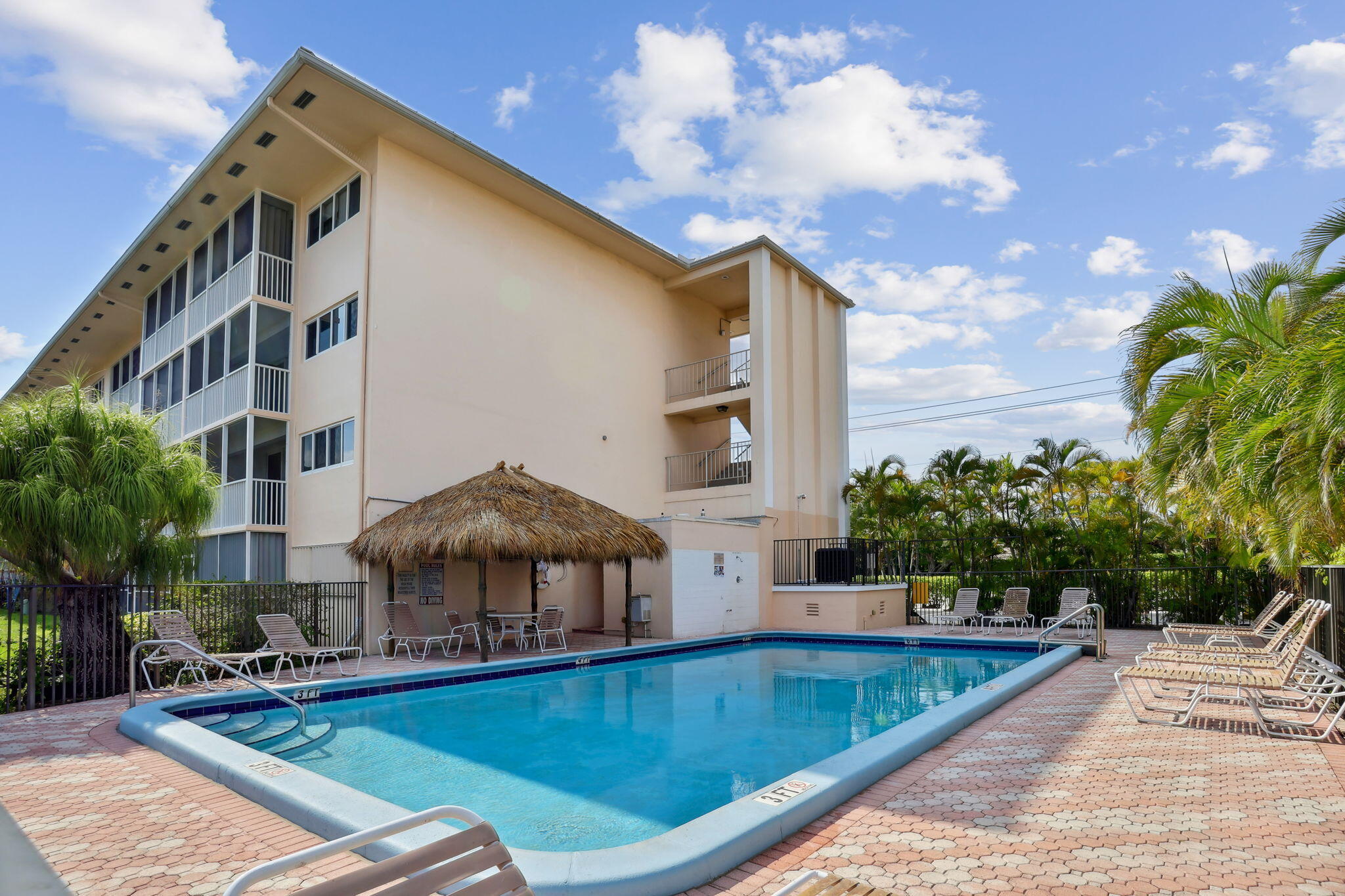 698 Northeast Spanish River Boulevard, Unit 24 Boca Raton, FL 33431 - Photo 18 of 25 a view of a patio with swimming pool