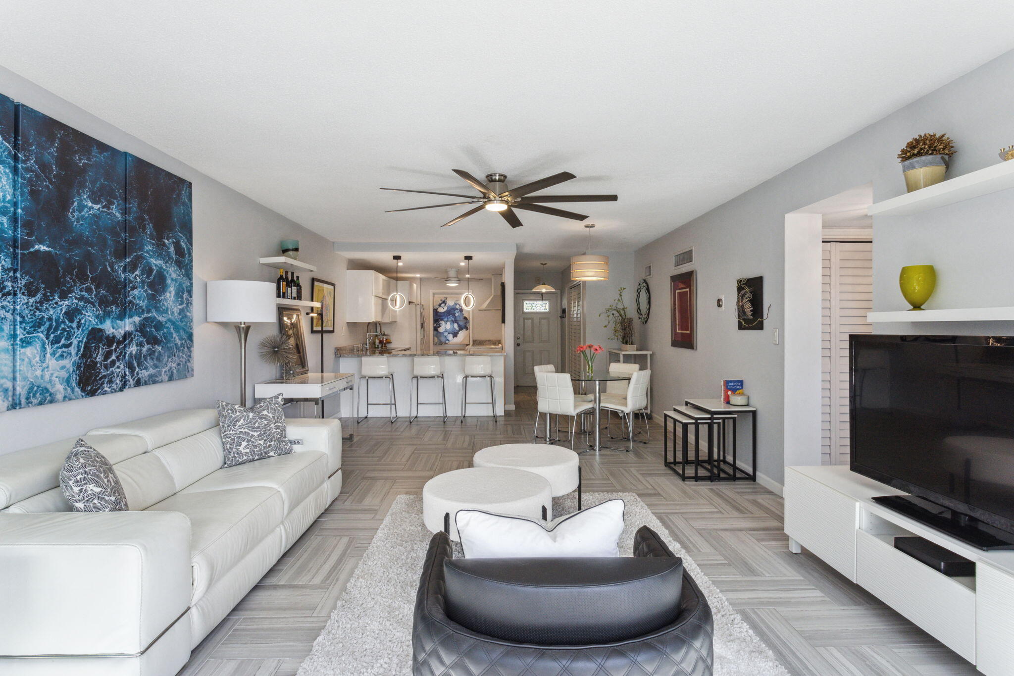 698 Northeast Spanish River Boulevard, Unit 24 Boca Raton, FL 33431 - Photo 2 of 25 a living room with furniture and a flat screen tv