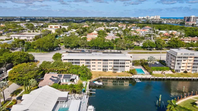 an aerial view of residential houses with outdoor space and lake view