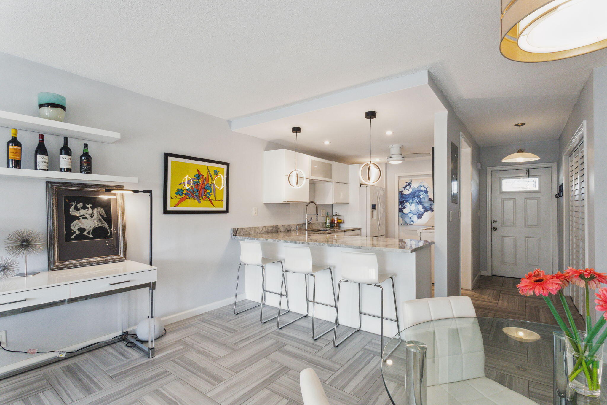 698 Northeast Spanish River Boulevard, Unit 24 Boca Raton, FL 33431 - Photo 3 of 25 a living room with furniture and a chandelier
