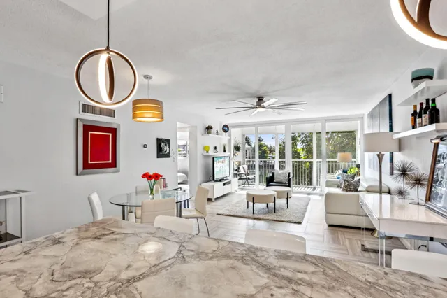 a living room with fireplace furniture and a large window