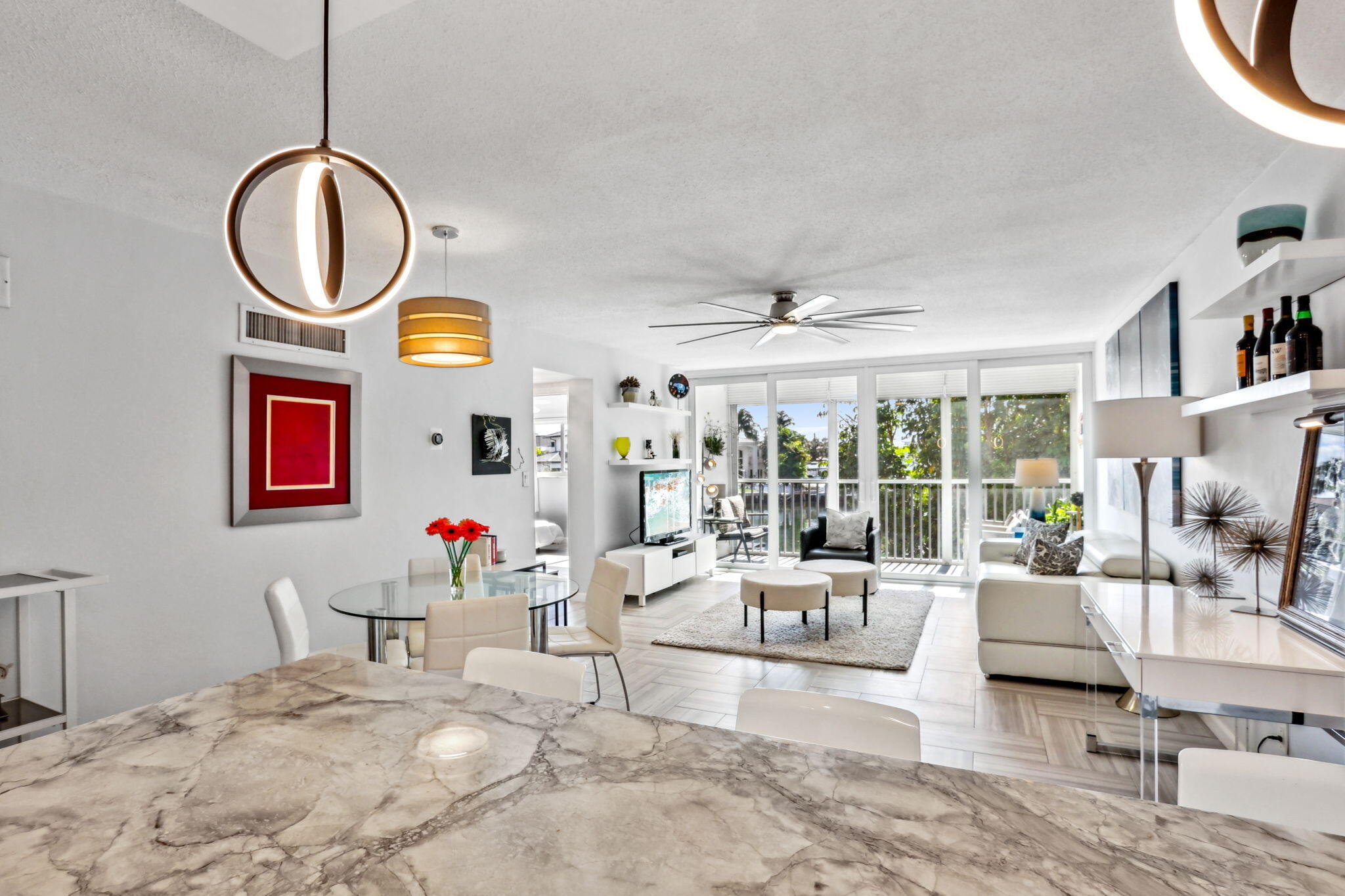 698 Northeast Spanish River Boulevard, Unit 24 Boca Raton, FL 33431 - Photo 6 of 25 a living room with fireplace furniture and a large window