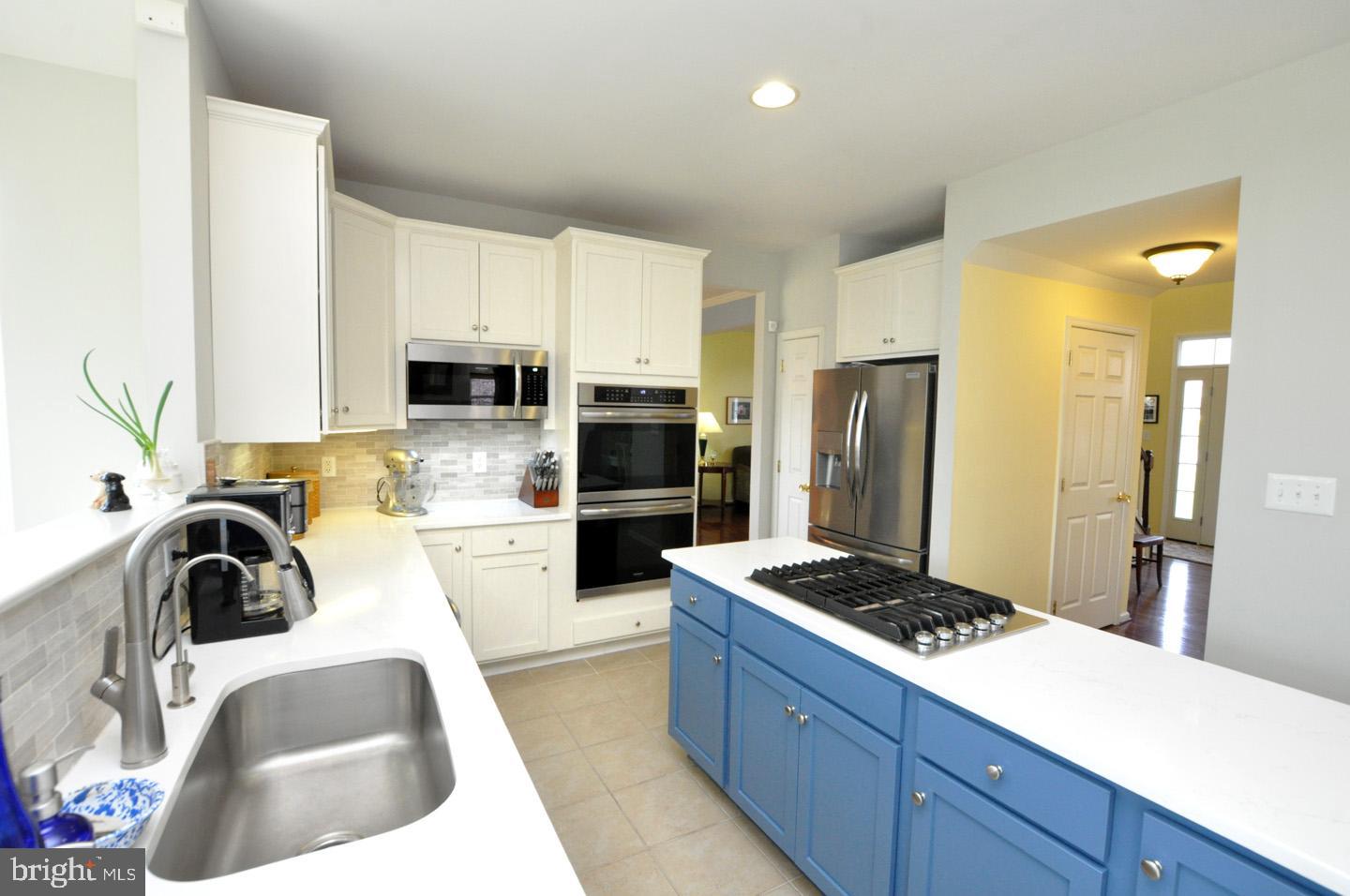 261 Jennings Way Mickleton, NJ 08056 - Photo 14 of 46 a kitchen with stainless steel appliances kitchen island granite countertop a sink stove and refrigerator