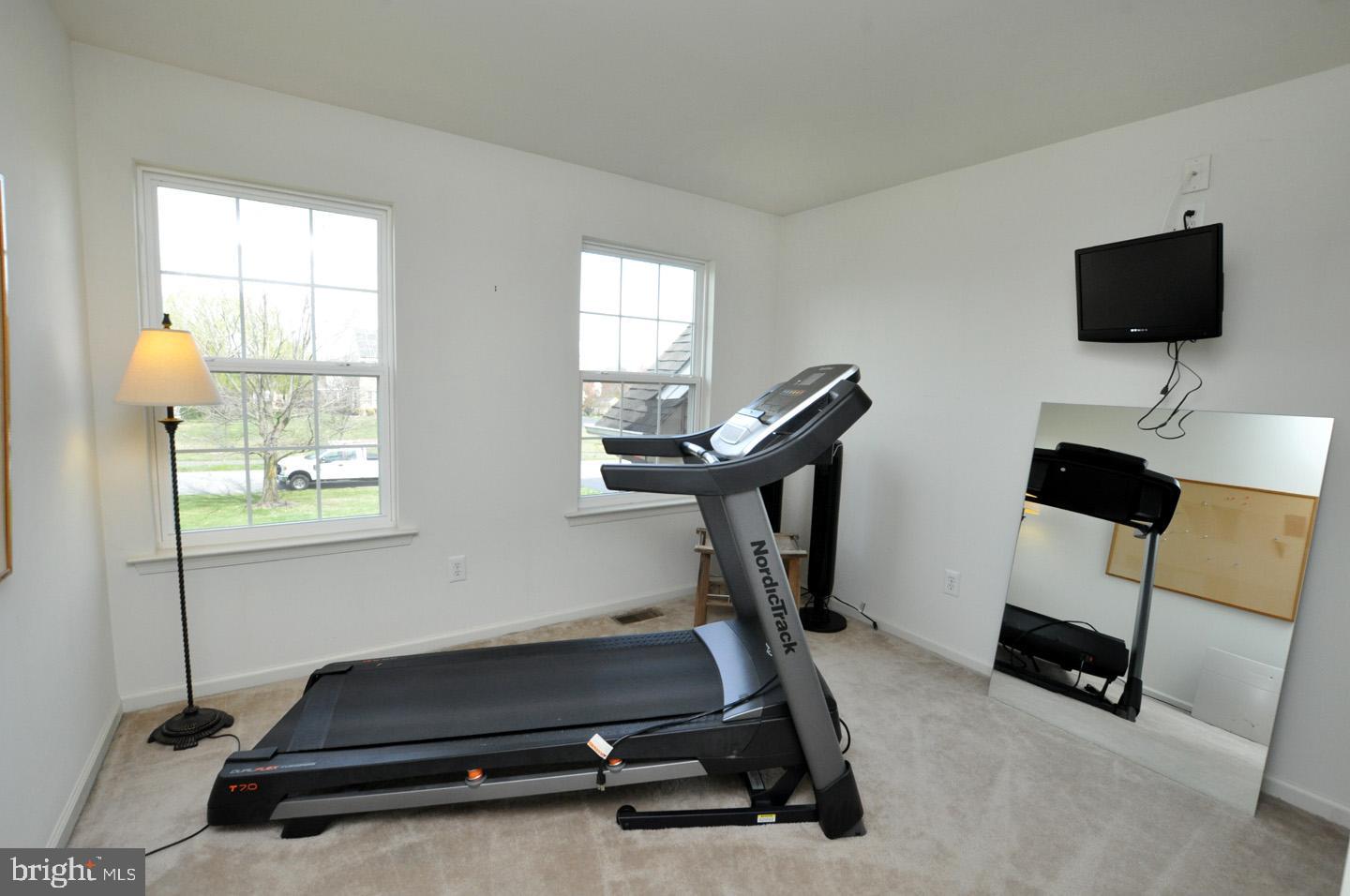 261 Jennings Way Mickleton, NJ 08056 - Photo 42 of 46 a room with gym equipment and a flat screen tv