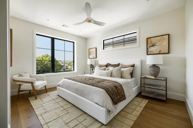 a spacious bedroom with a large bed and a window