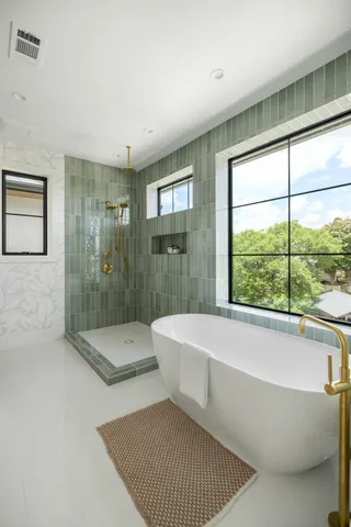 a bathroom with a bathtub and a shower