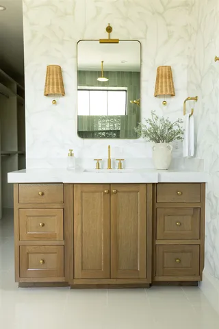 a bathroom with a sink vanity and mirror