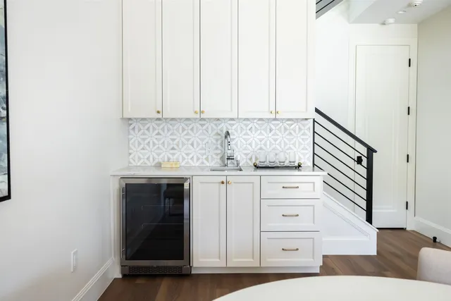 a kitchen with granite countertop white cabinets and white appliances