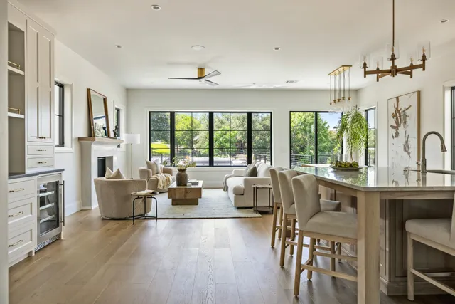 a living room with furniture and large windows