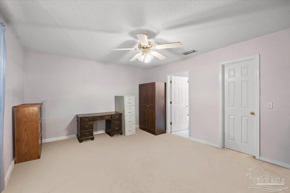 6892 Yucatan Street Milton, FL 32570 - Photo 14 of 41 a view of a livingroom with furniture and a ceiling fan