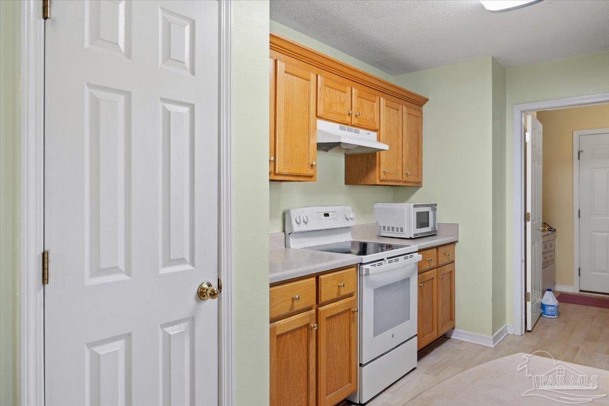 6892 Yucatan Street Milton, FL 32570 - Photo 16 of 41 a kitchen with a sink stove and cabinets