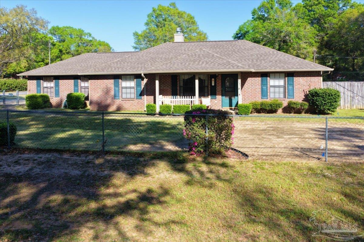 6892 Yucatan Street Milton, FL 32570 - Photo 2 of 41 a front view of a house with a yard