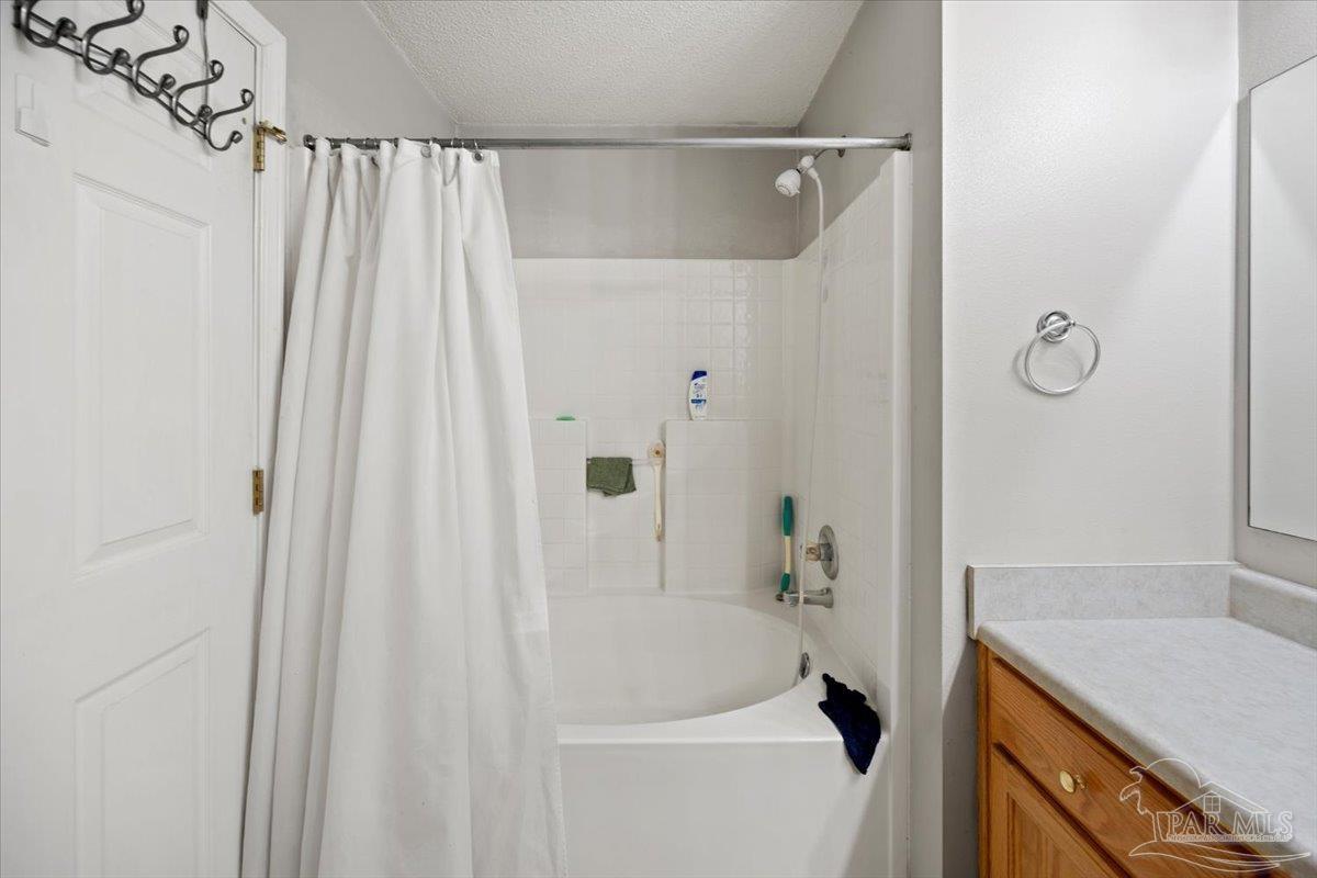 6892 Yucatan Street Milton, FL 32570 - Photo 21 of 41 a bathroom with a granite countertop sink and a bathtub