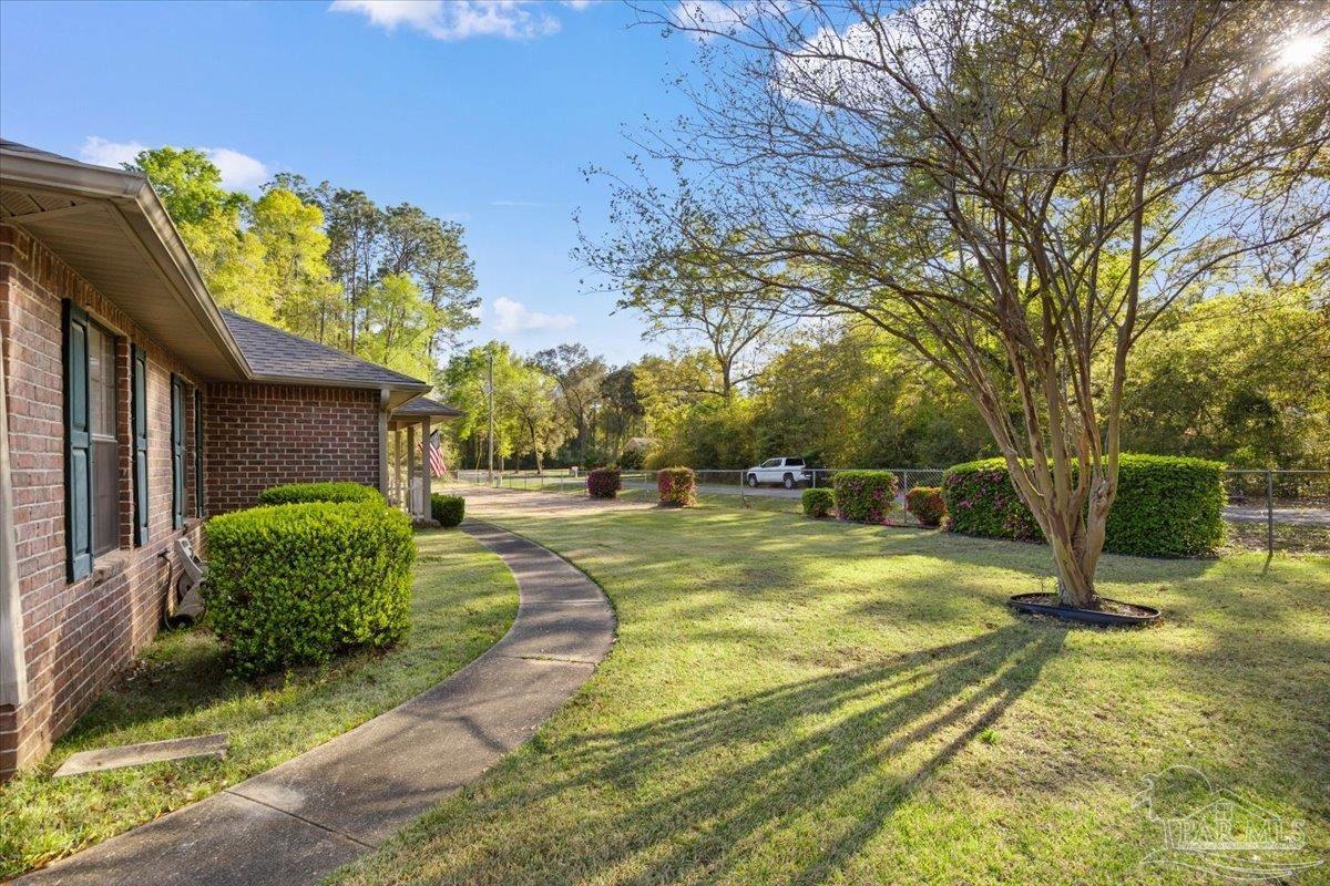 6892 Yucatan Street Milton, FL 32570 - Photo 23 of 41 a view of a house with basketball court