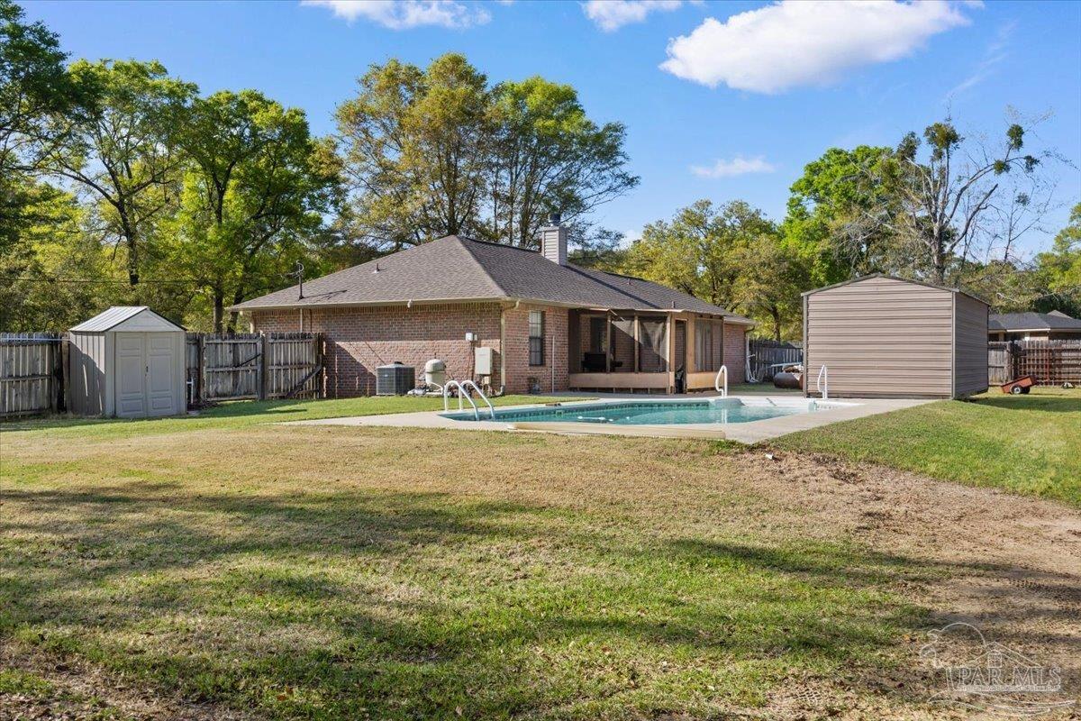 6892 Yucatan Street Milton, FL 32570 - Photo 24 of 41 a front view of a house with a garden and porch