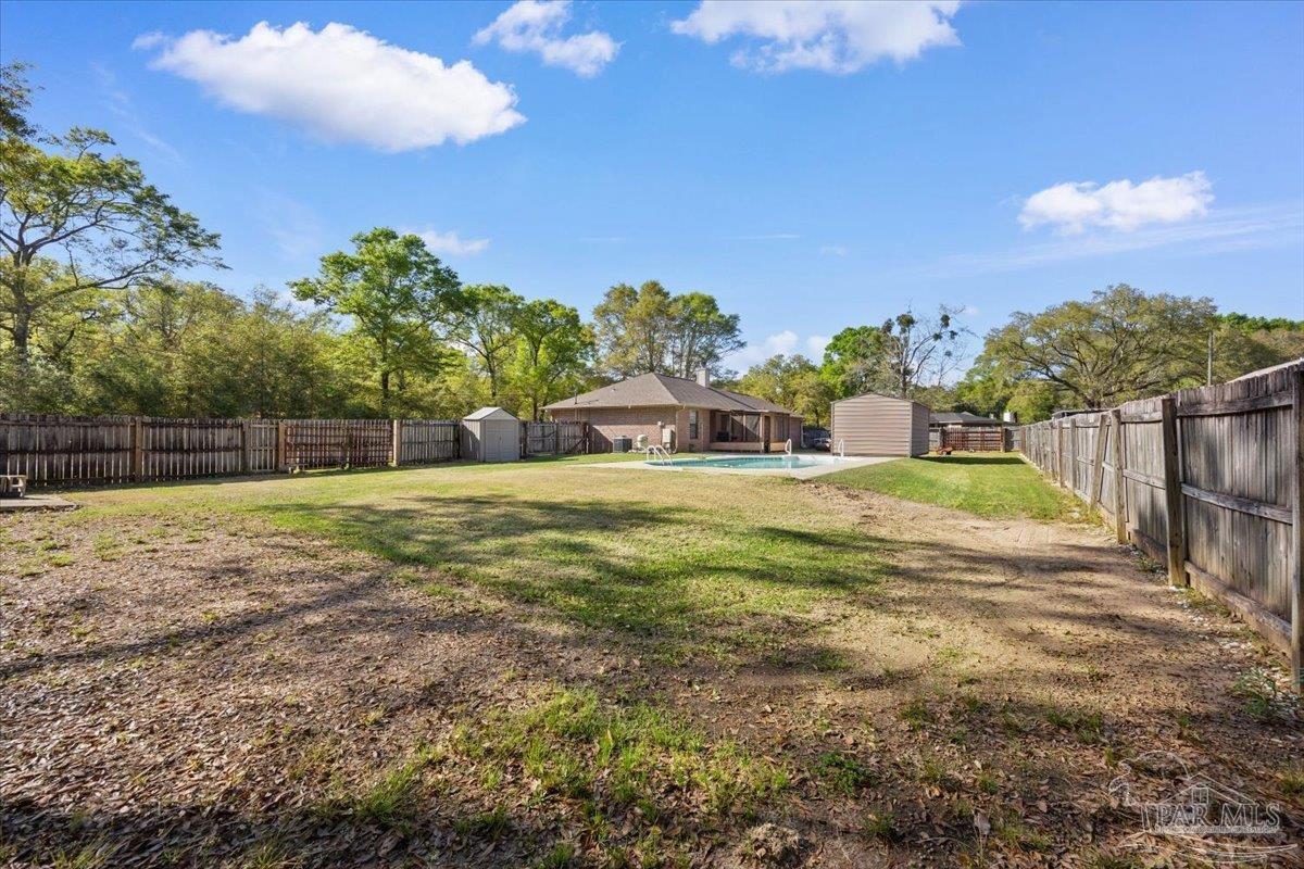 6892 Yucatan Street Milton, FL 32570 - Photo 28 of 41 a view of a house with a yard