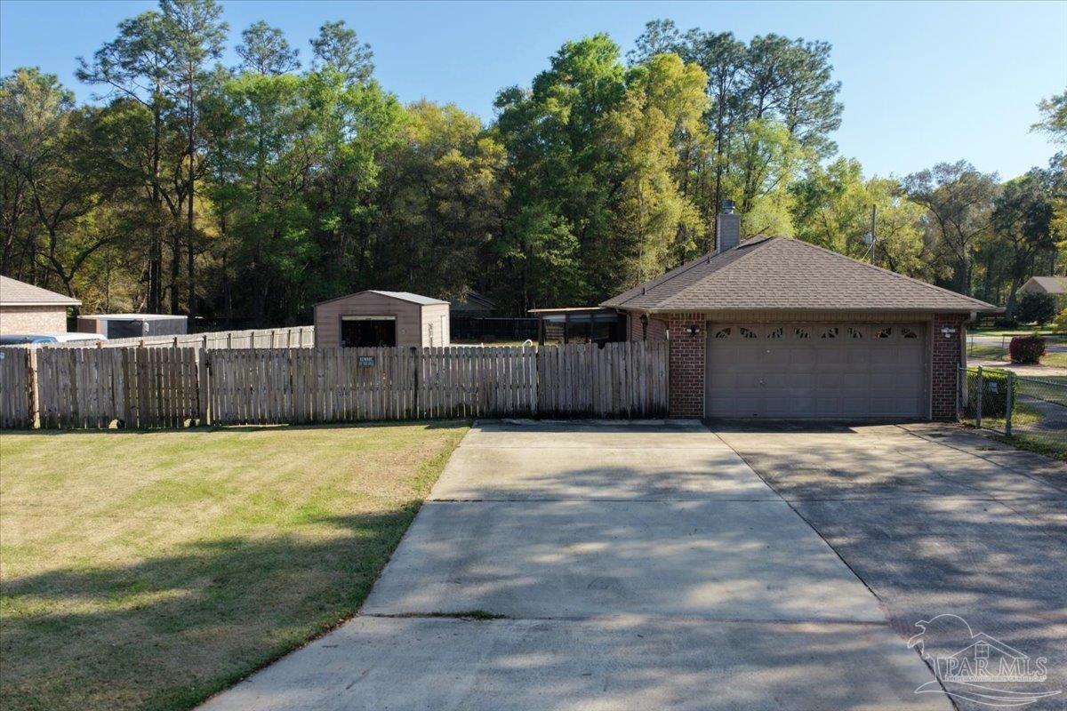 6892 Yucatan Street Milton, FL 32570 - Photo 31 of 41 a front view of a house with a yard
