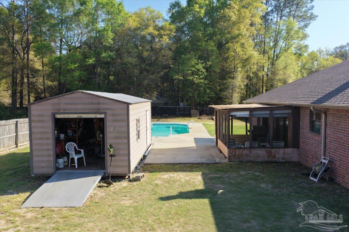 6892 Yucatan Street Milton, FL 32570 - Photo 32 of 41 a view of a house with a yard porch and furniture