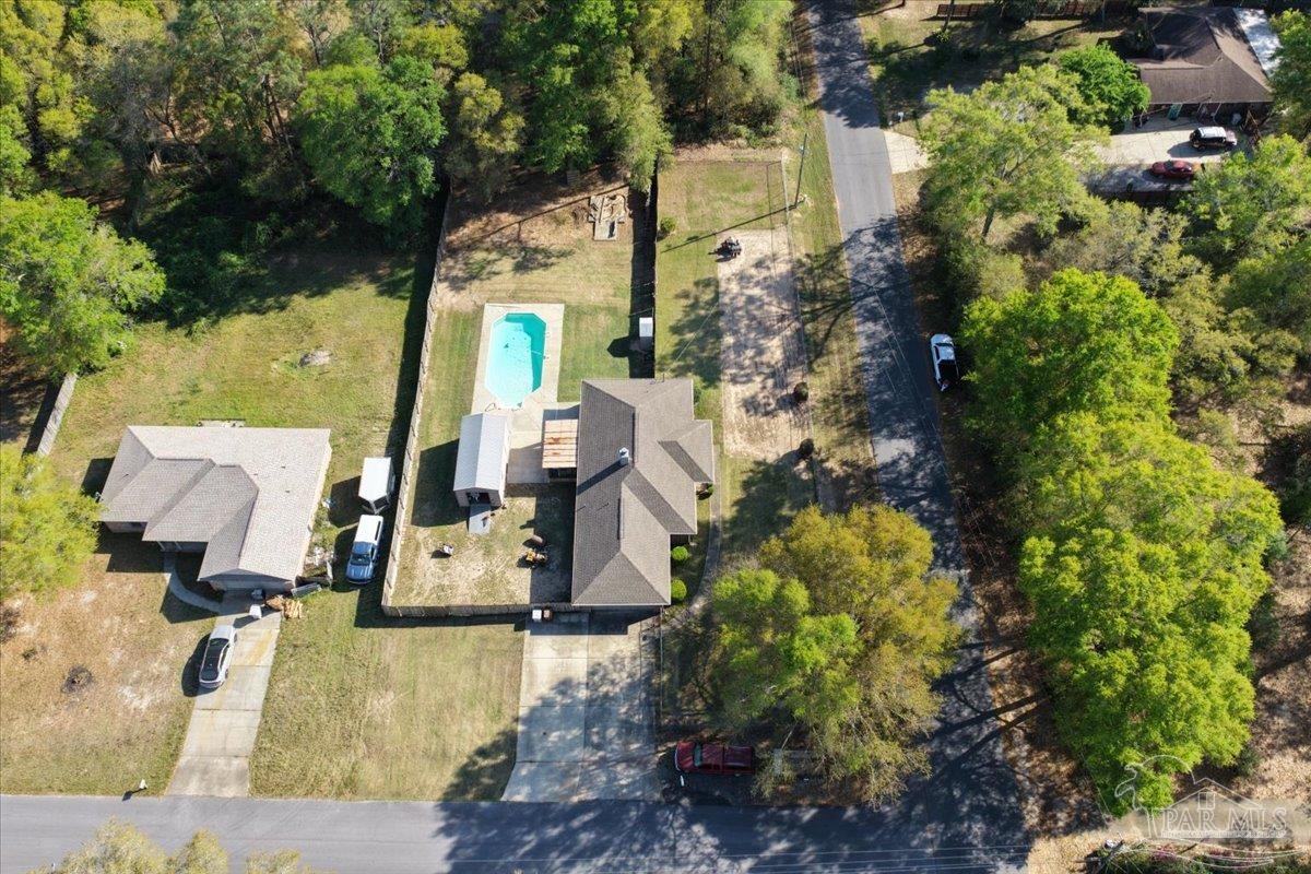 6892 Yucatan Street Milton, FL 32570 - Photo 36 of 41 an aerial view of a house with a yard swimming pool and large trees