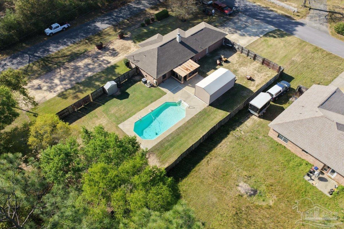 6892 Yucatan Street Milton, FL 32570 - Photo 38 of 41 an aerial view of a house with a garden and swimming pool