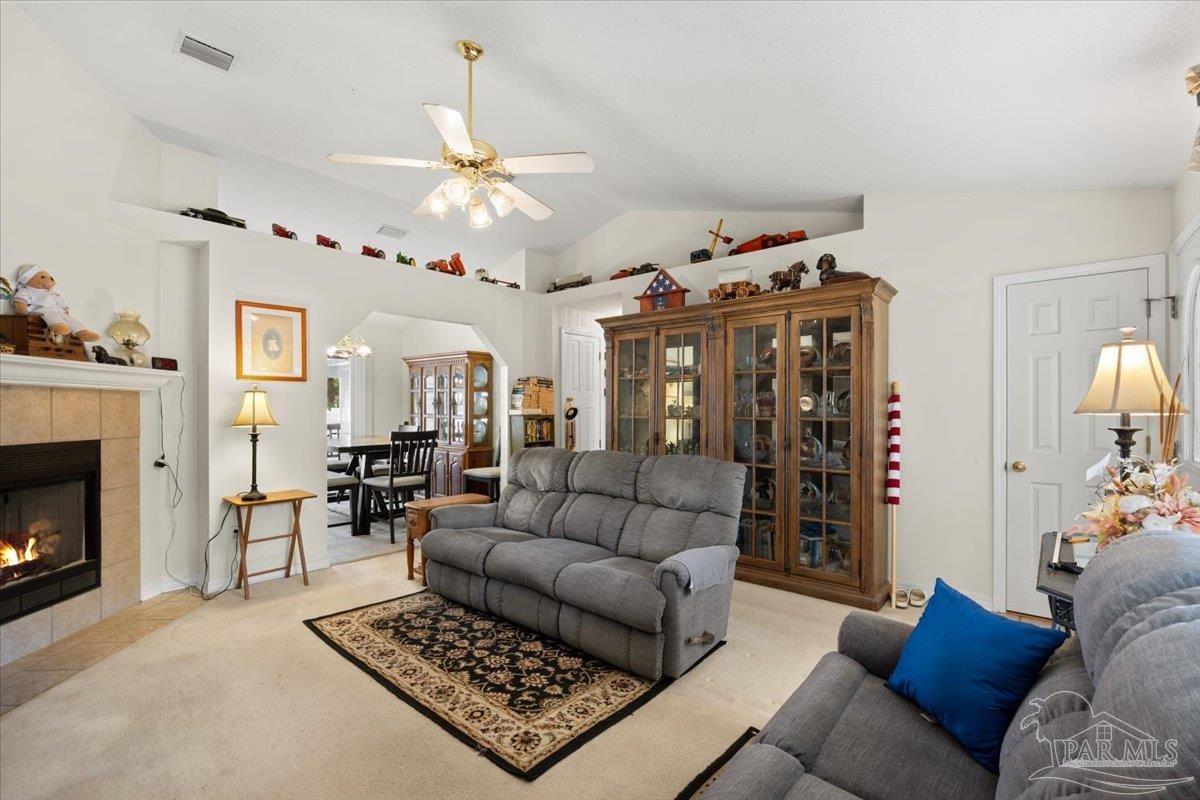 6892 Yucatan Street Milton, FL 32570 - Photo 6 of 41 a living room with furniture and a fireplace