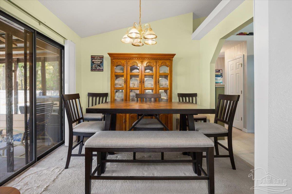 6892 Yucatan Street Milton, FL 32570 - Photo 7 of 41 a view of a dining room with furniture window and outside view