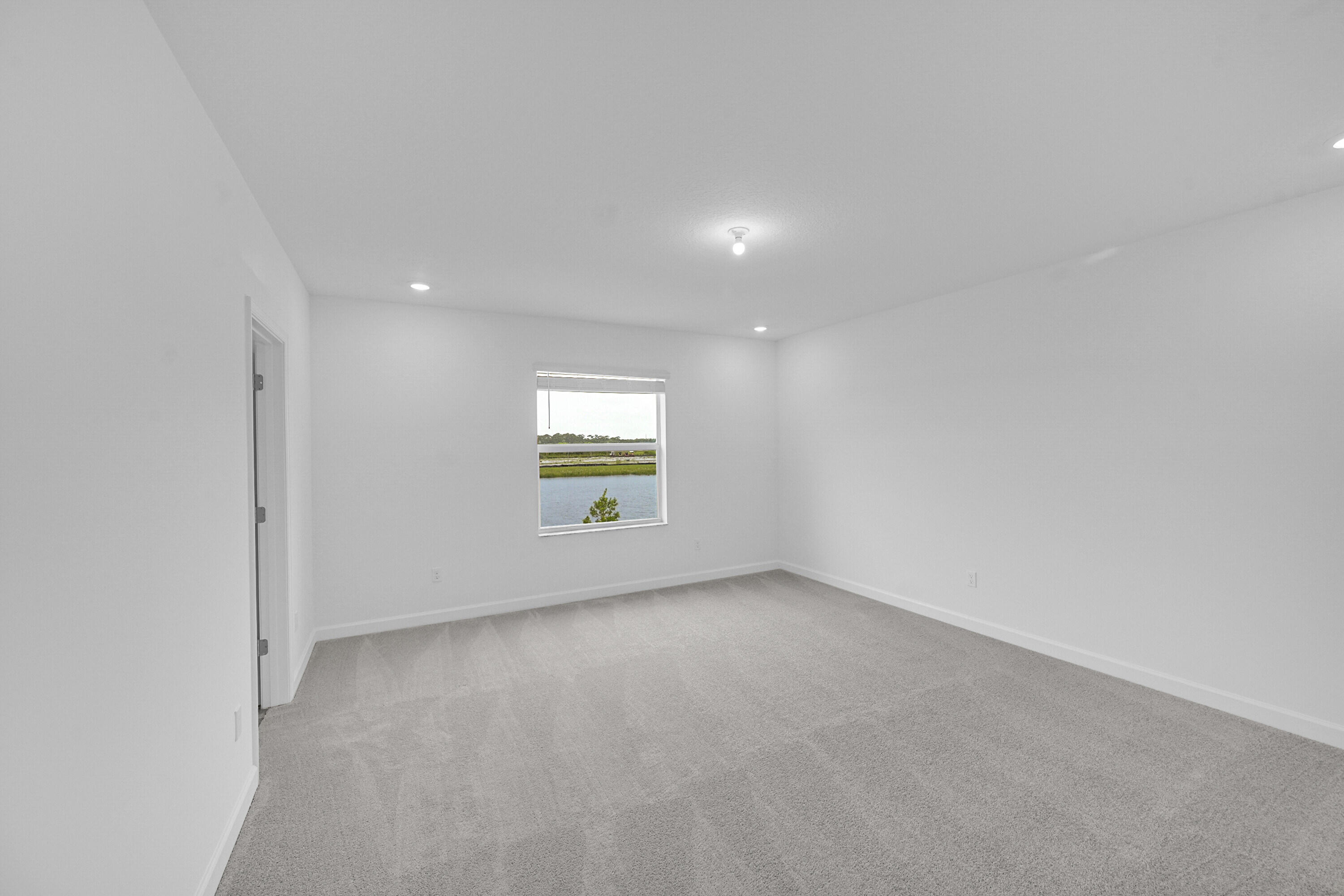 3514 Angler Drive Fort Pierce, FL 34946 - Photo 17 of 32 an empty room with a window and a fireplace