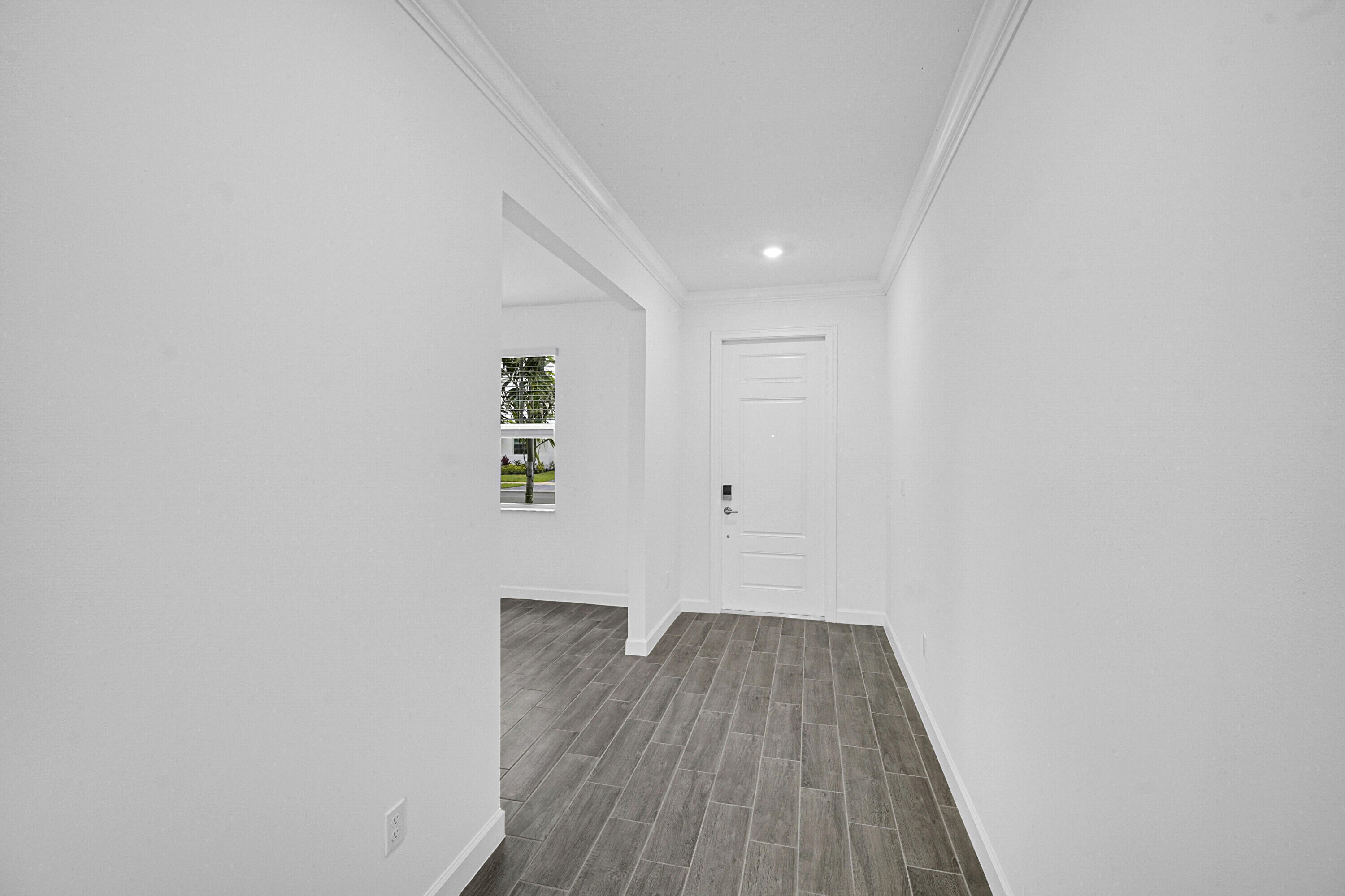 3514 Angler Drive Fort Pierce, FL 34946 - Photo 3 of 32 a view of a hallway with wooden floor