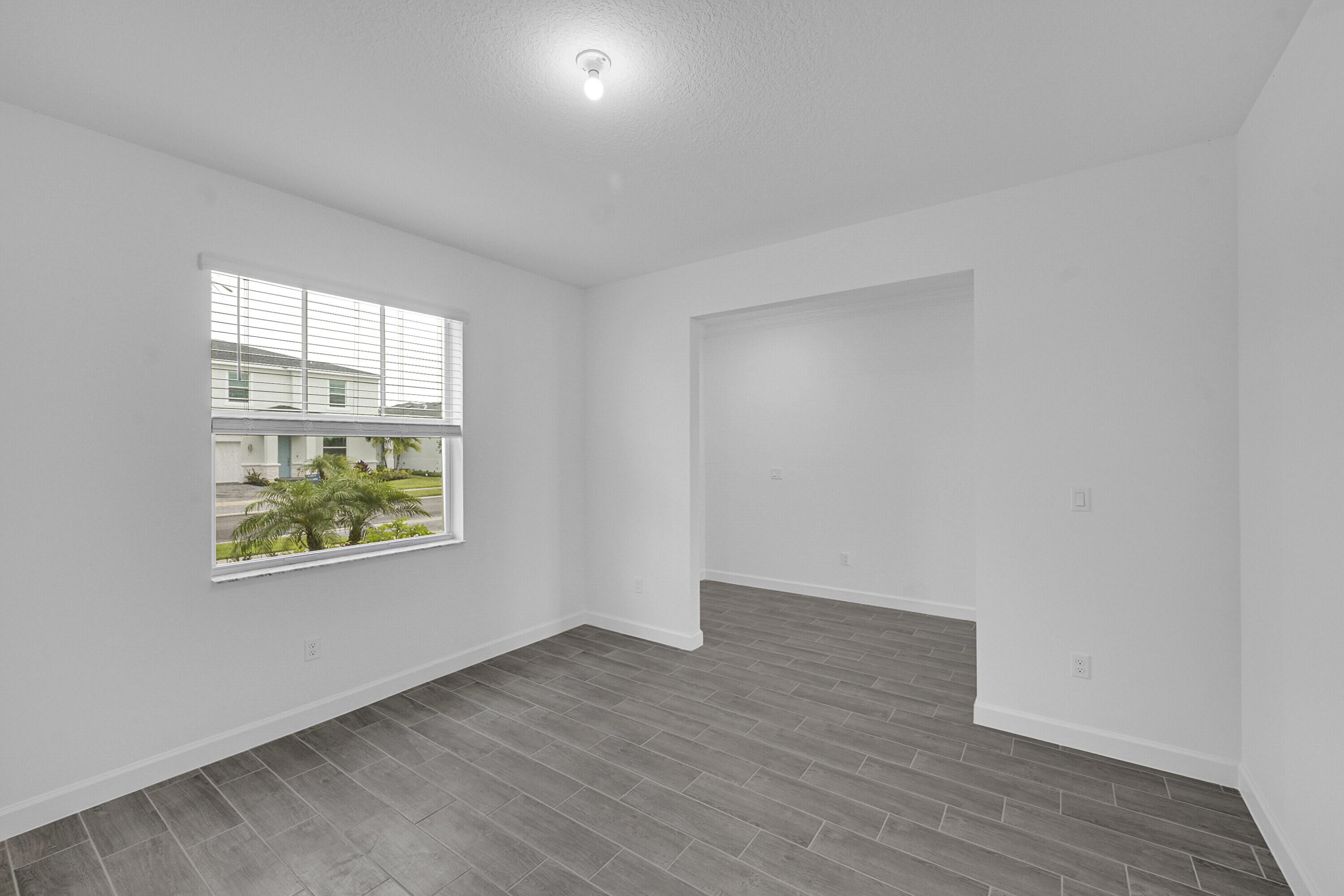 3514 Angler Drive Fort Pierce, FL 34946 - Photo 5 of 32 an empty room with wooden floor and windows