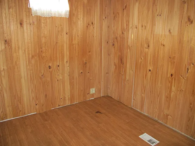 a view of an empty room with wooden walls