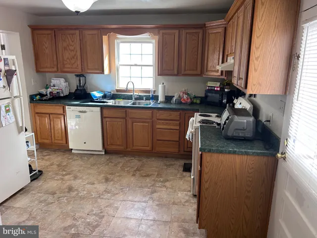a kitchen with a sink cabinets and window