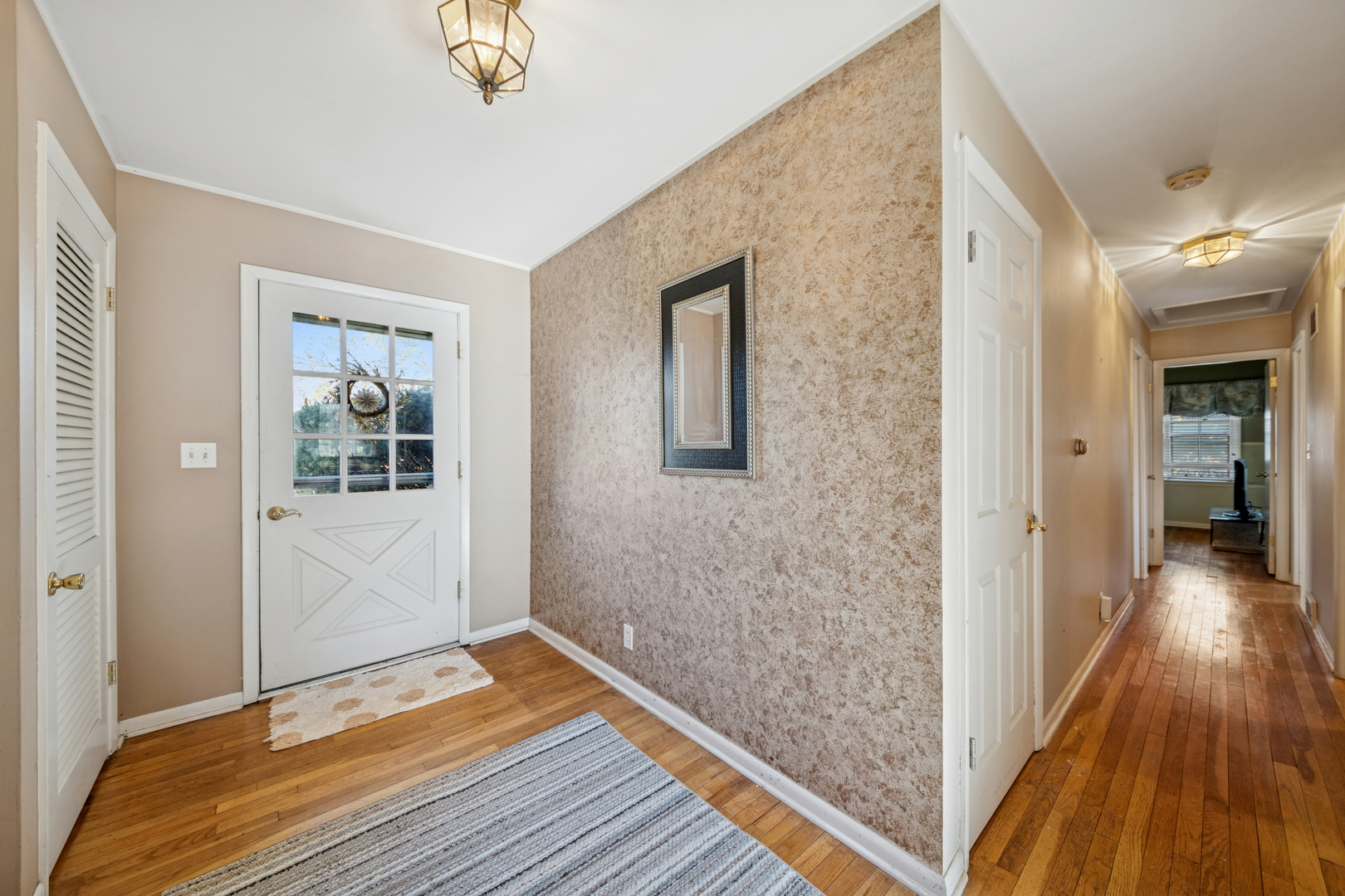 532 Shabbona Trail Batavia, IL 60510 - Photo 12 of 19 a view of a hallway with wooden floor and closet