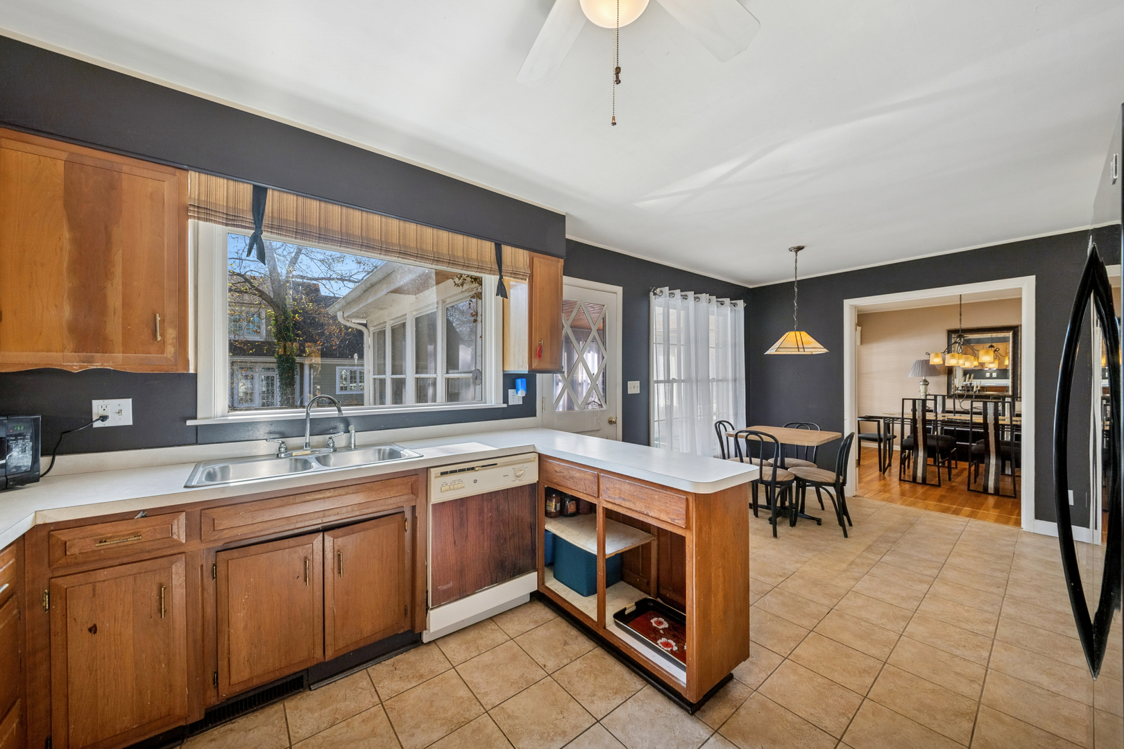 532 Shabbona Trail Batavia, IL 60510 - Photo 9 of 19 a kitchen with sink a table and chairs