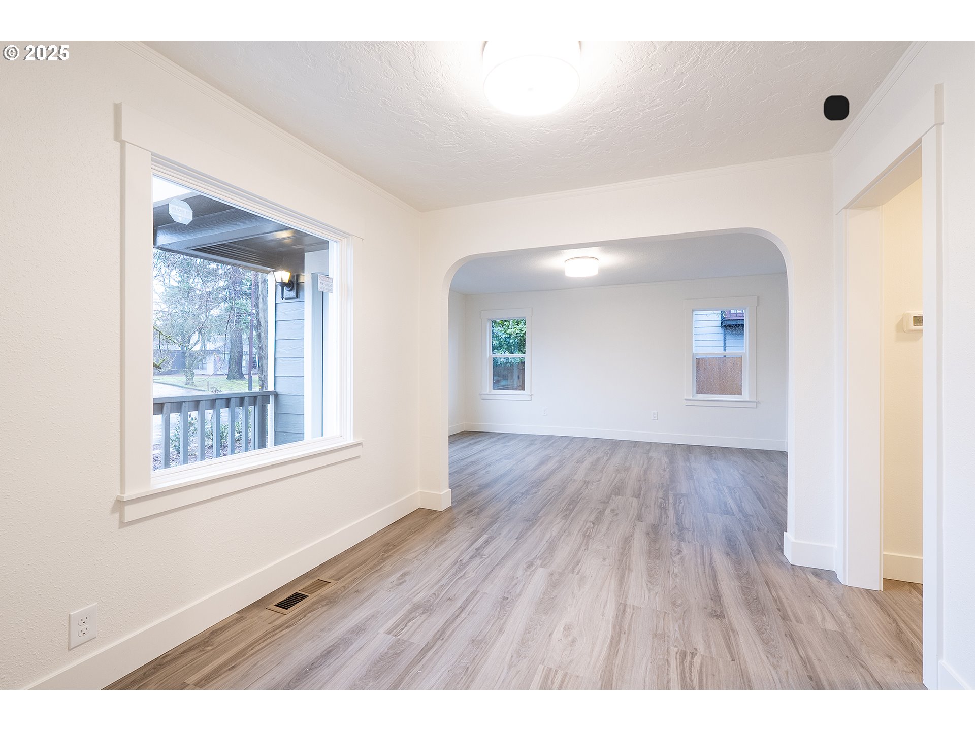 11129 Southeast Stark Street Portland, OR 97216 - Photo 8 of 20 a view interior of a house with wooden floor and windows