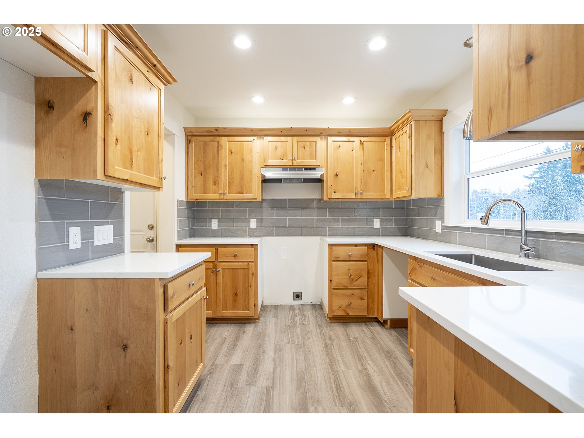 11129 Southeast Stark Street Portland, OR 97216 - Photo 9 of 20 a kitchen with a sink stove and cabinets