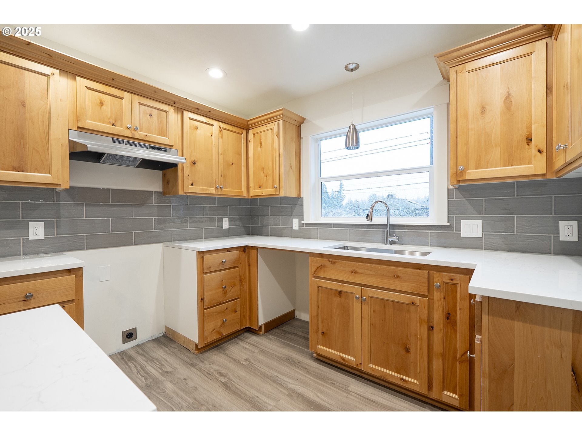 11129 Southeast Stark Street Portland, OR 97216 - Photo 10 of 20 a kitchen with stainless steel appliances granite countertop a sink a stove cabinets counter space and a window