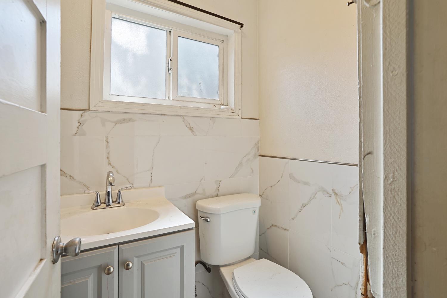 2018 East Myrtle Street Stockton, CA 95205 - Photo 25 of 41 a bathroom with a toilet sink and mirror