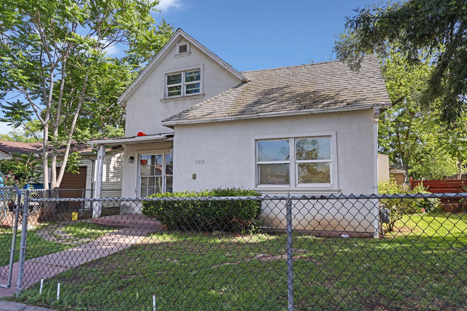 2018 East Myrtle Street Stockton, CA 95205 - Photo 5 of 41 a front view of a house with a garden