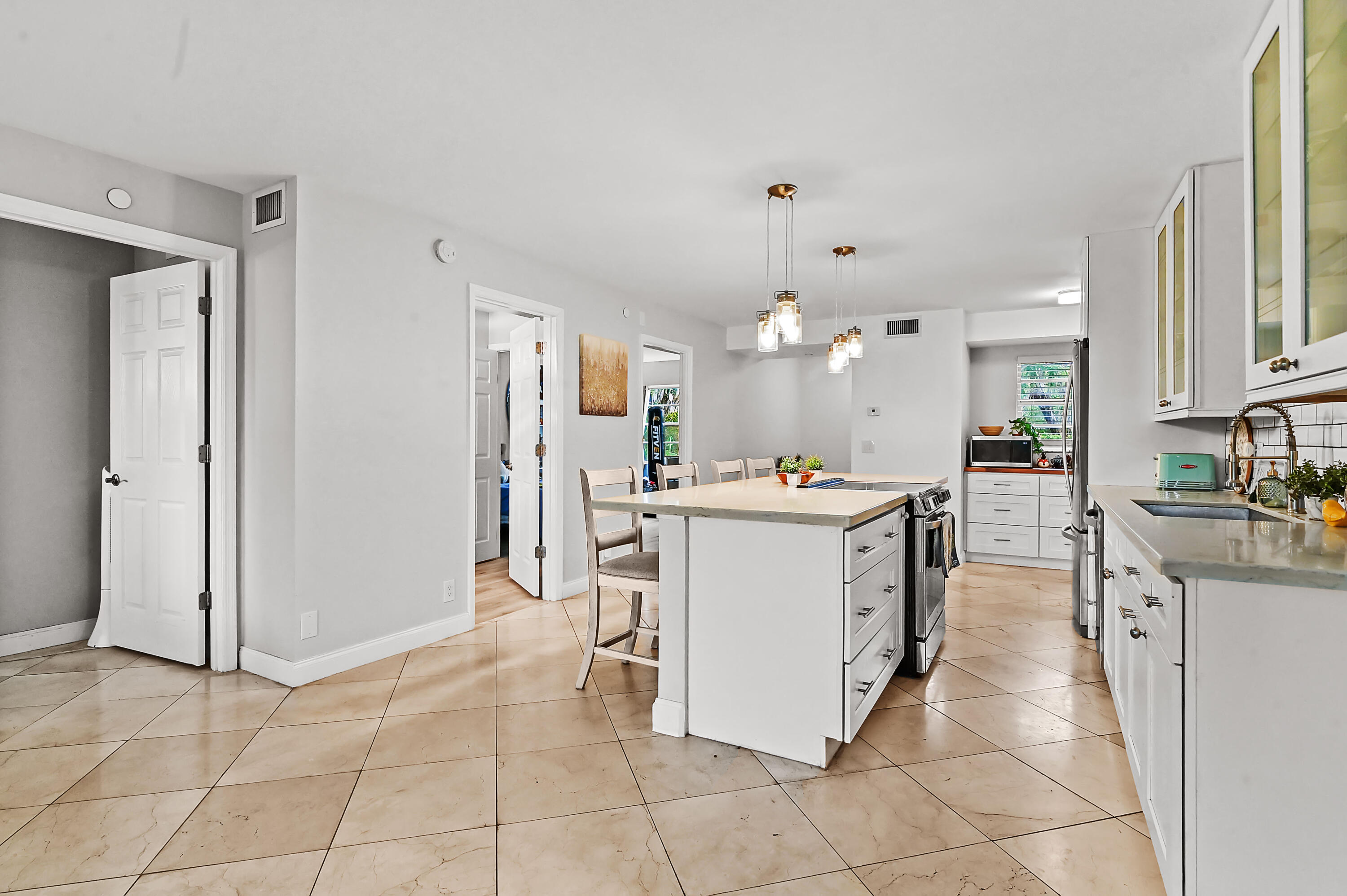 6400 Northwest 2nd Avenue, Unit 124 Boca Raton, FL 33487 - Photo 10 of 33 a kitchen with appliances cabinets and furniture