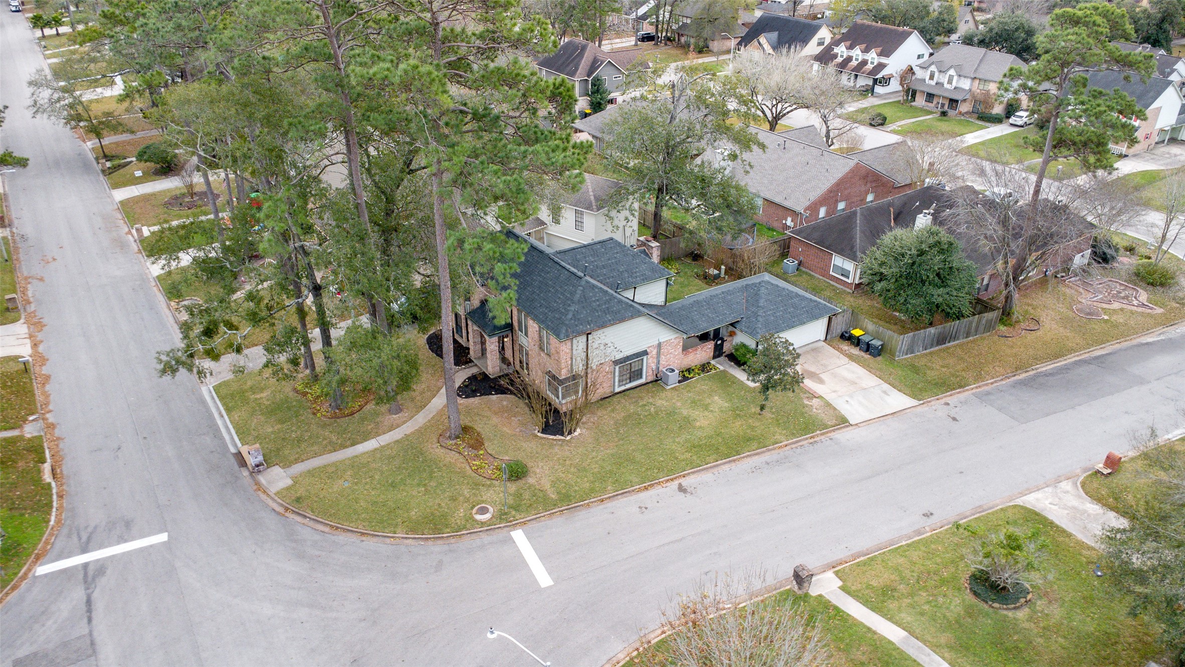41 Windsor Drive Conroe, TX 77304 - Photo 37 of 39 Another bird’s-eye view of the property layout, highlighting the detached garage, driveway access, and fenced backyard.
