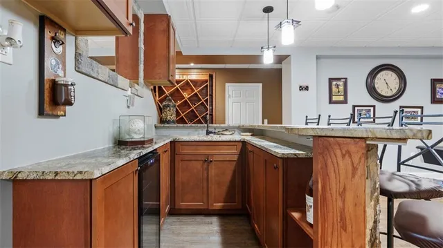 a bathroom with a sink a large mirror and a clock on the wall