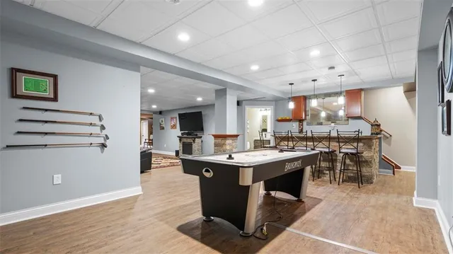 a view of a dining area kitchen with stainless steel appliances granite countertop lots of counter top space and furniture