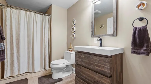 a bathroom with a sink a toilet and a mirror