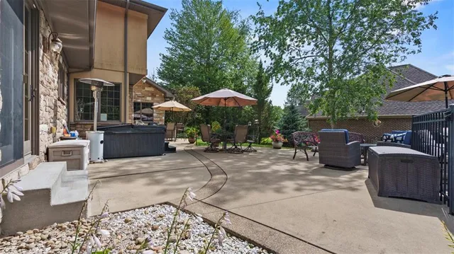 a view of a patio with furniture and a fire pit