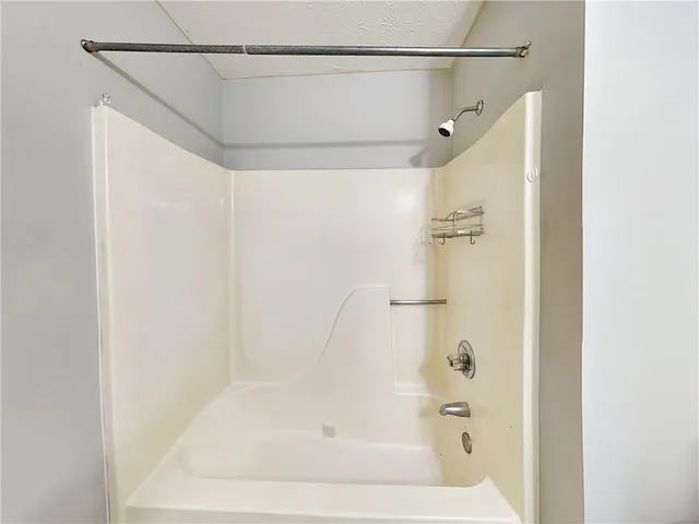 a bathroom with a shower and a bath tub