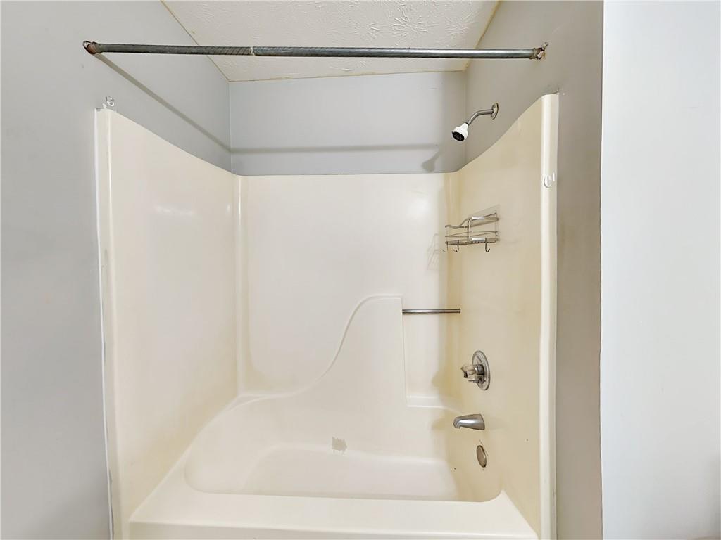 2140 Kings Gate Circle Southwest, Unit B Snellville, GA 30078 - Photo 11 of 18 a bathroom with a shower and a bath tub