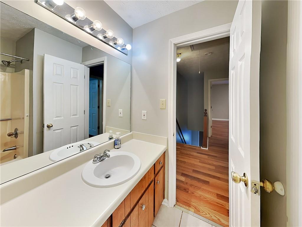 2140 Kings Gate Circle Southwest, Unit B Snellville, GA 30078 - Photo 14 of 18 a bathroom with a sink and a mirror