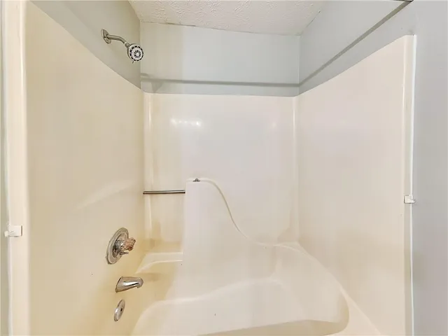 a bathroom with a bathtub and shower